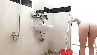 Naked maid cleans office space. Maid without panties. The naked maid cleans the toilet and shower. Maid without panties.